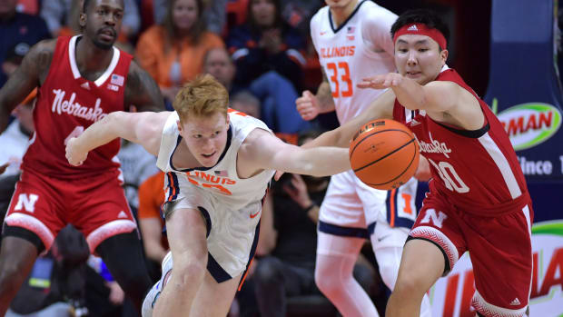 Feb 4, 2024; Champaign, Illinois, USA; Illinois Fighting Illini guard Luke Goode (10) and Nebraska Cornhuskers guard Keisei Tominaga (30) chase a loose ball during the second half at State Farm Center.